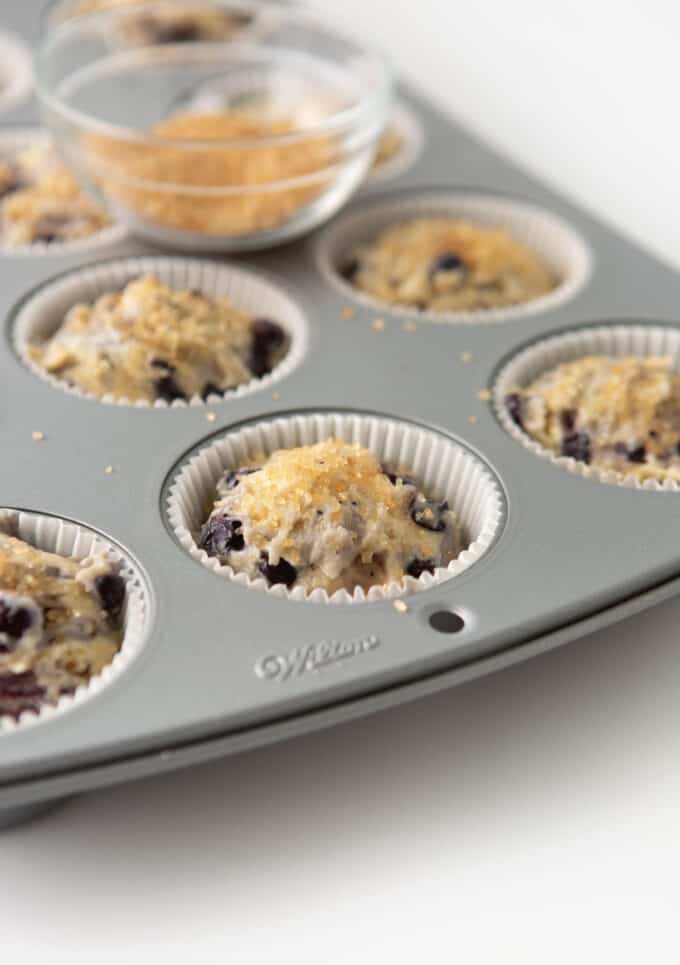 pan of sour cream blueberry muffins with turbinado sugar