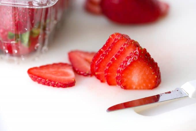 slicing strawberries with knife