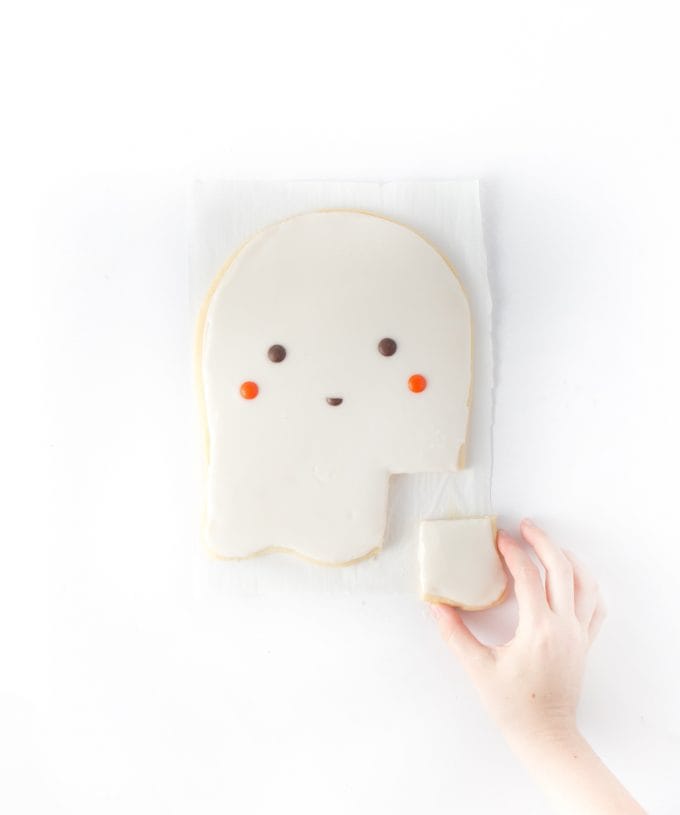 Hand reaching in for sugar ghost cookie bar