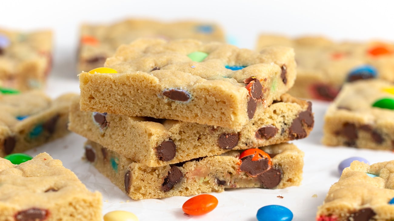 Stack of Chewy M&M Cookie bars cut into squares