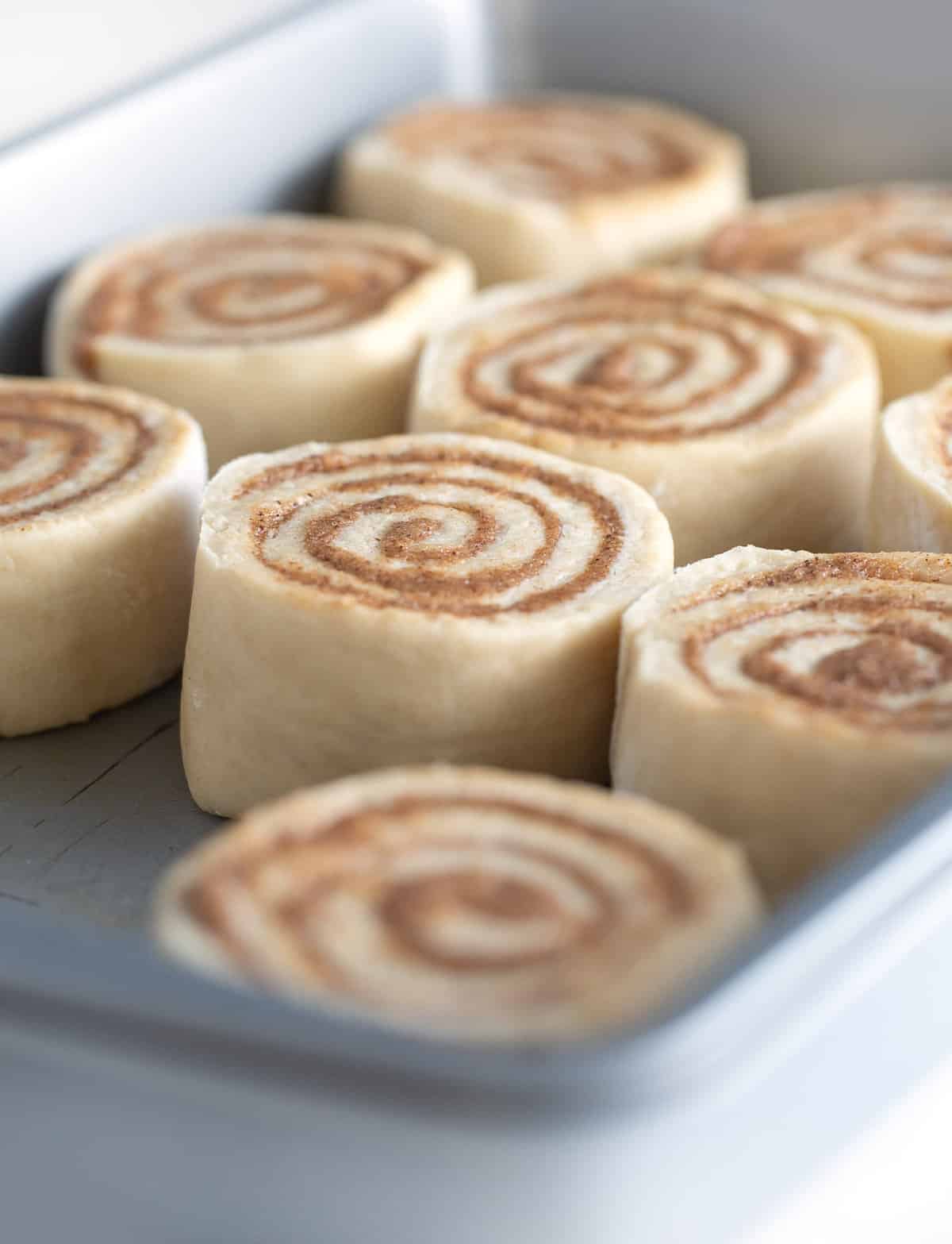 9x13 metal pan of unbaked cinnamon roll dough