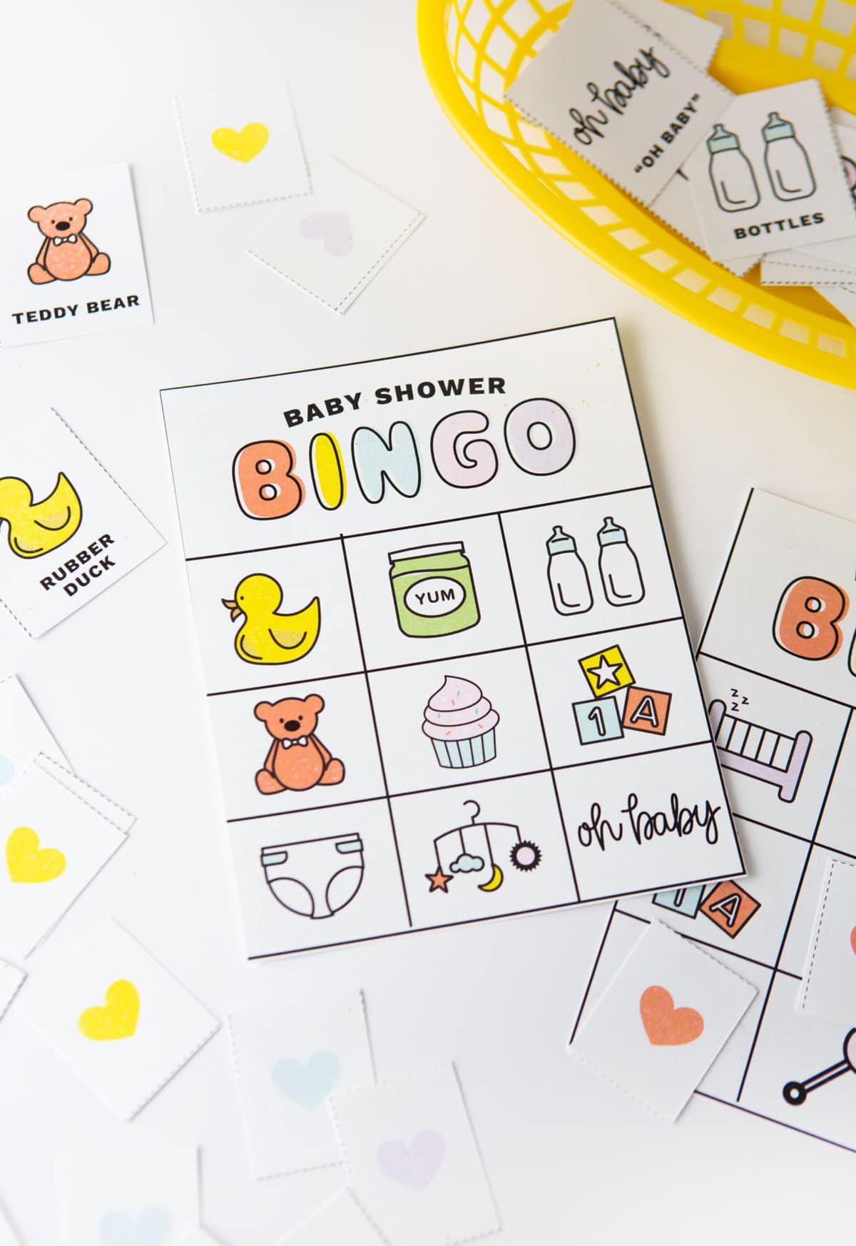 Baby shower bingo cards with pictures and icons; rubber duck, teddy bear, bottles, cupcake, diaper, blocks, baby food