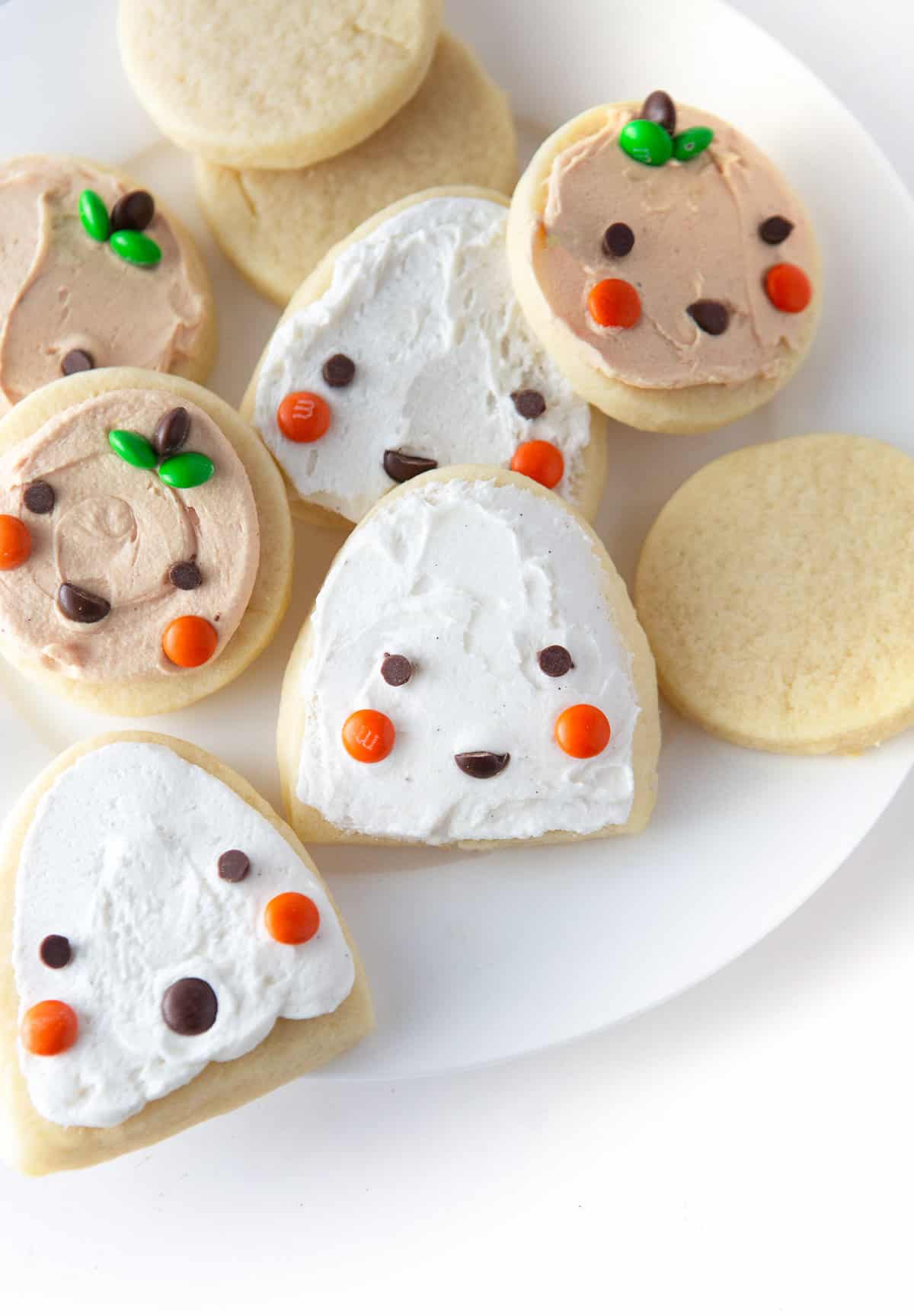 Easy Halloween Pumpkin and Ghost Cookies using cut out sugar cookies and mini M&M's
