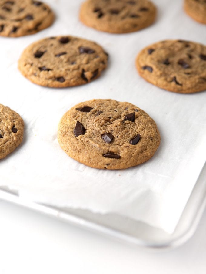 Baking tray of peanut butter chocolate chip cookies on parchment