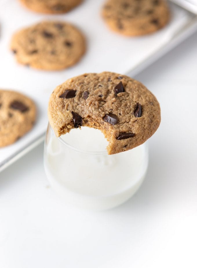 Peanut butter chocolate chip cookie on glass of milk