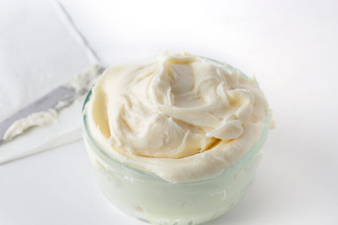 glass bowl of white cream cheese frosting
