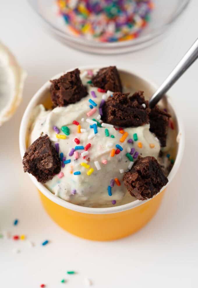 cup of cake batter ice cream with brownie bites