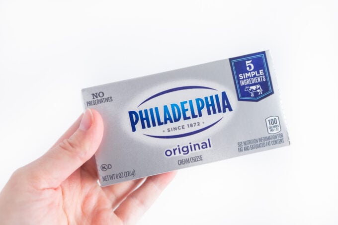hand holding box of philadelphia cream cheese