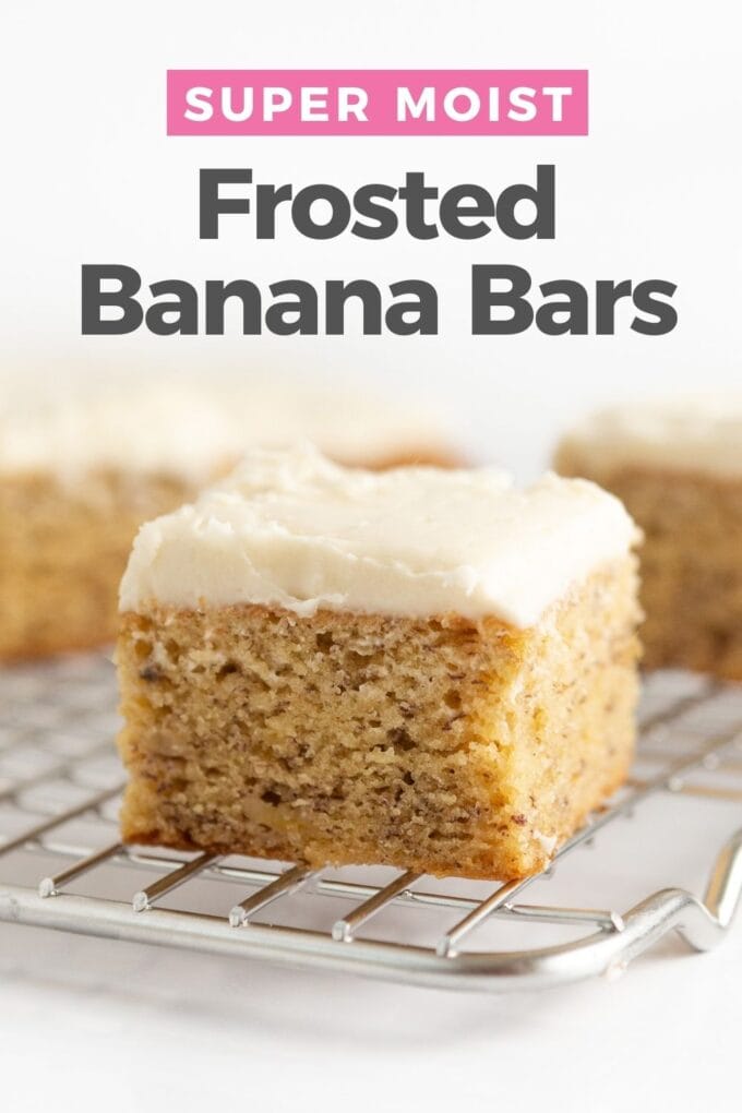 Banana bars with cream cheese frosting cut into squares on wire cooling rack