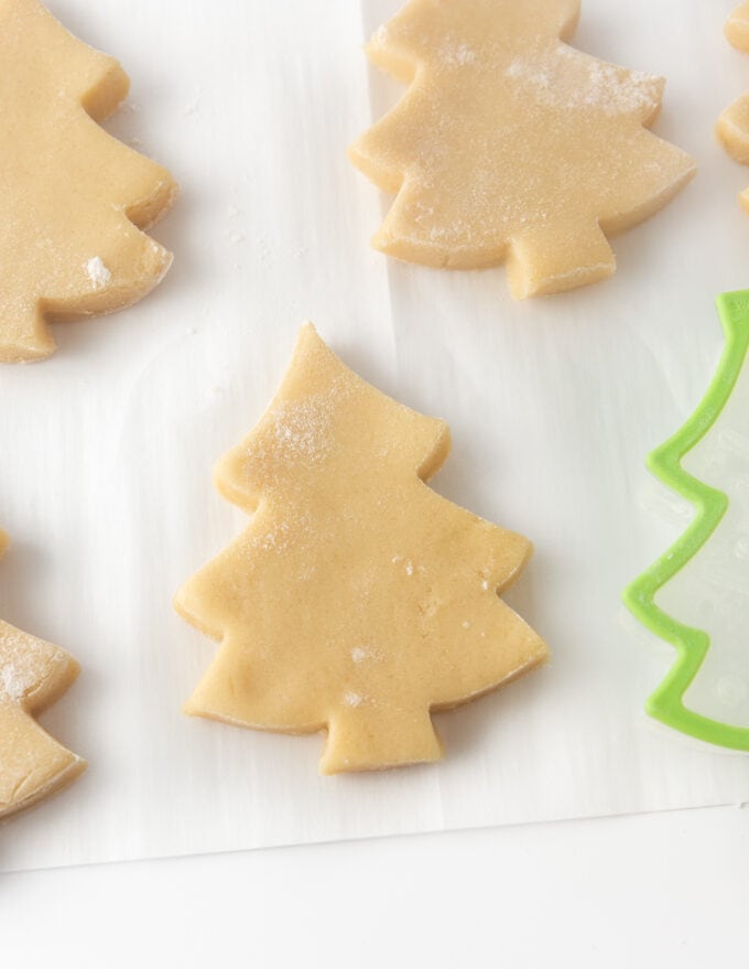 cut out sugar cookie dough in christmas tree shape