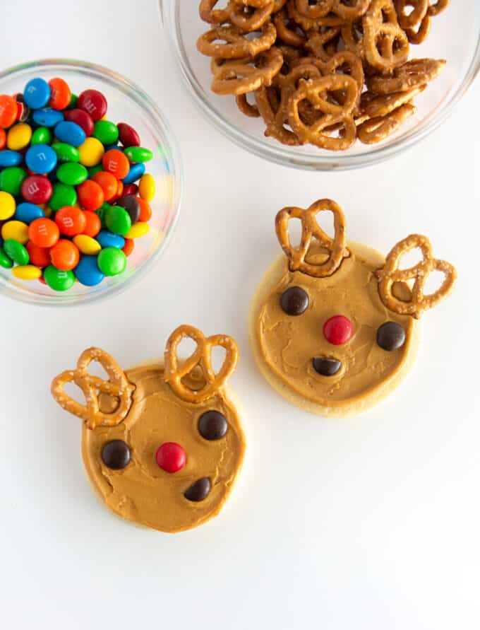 brown reindeer cookies with M&M eyes and pretzel antlers