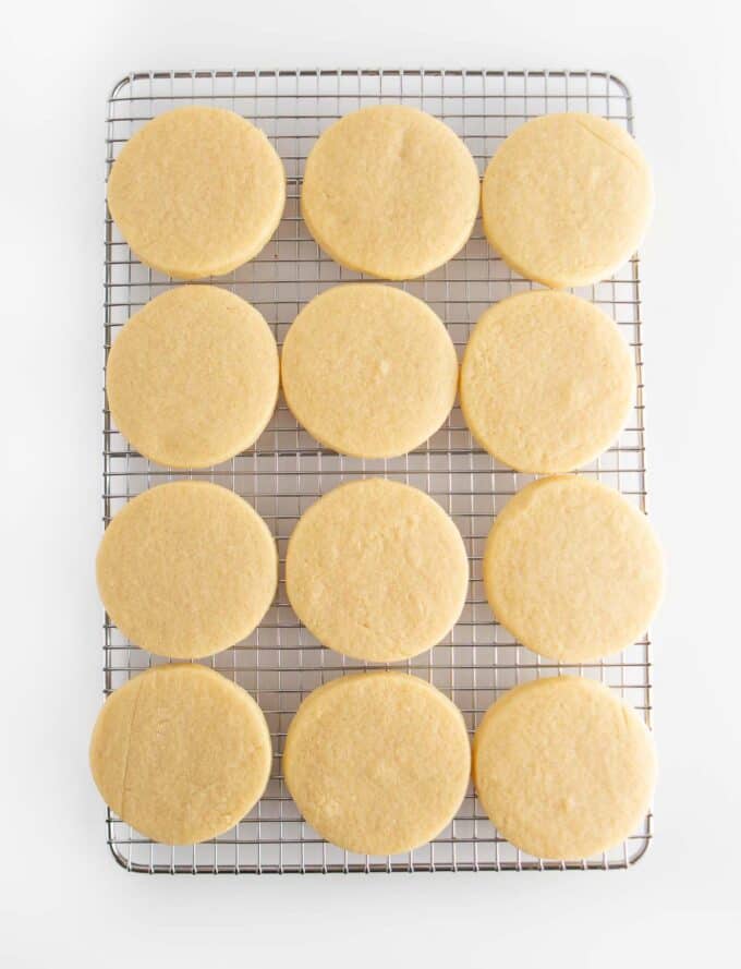 unfrosted circle sugar cookies on cooling rack