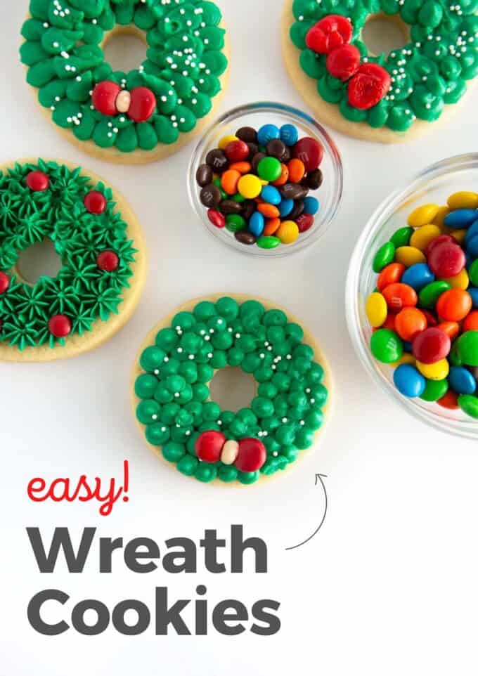 green buttercream wreath sugar cookies with red m&m candy to make a bow