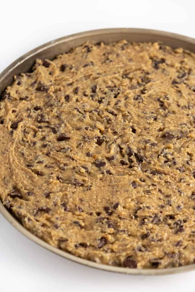 pan of unbaked chocolate chip cookie cake dough