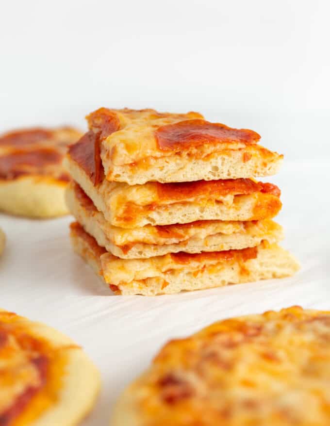 stack of sliced mini pepperoni pizzas