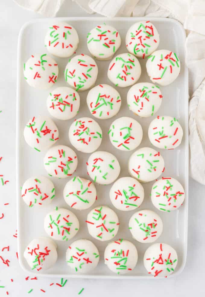 tray of white chocolate sugar cookie truffles with red and green sprinkles
