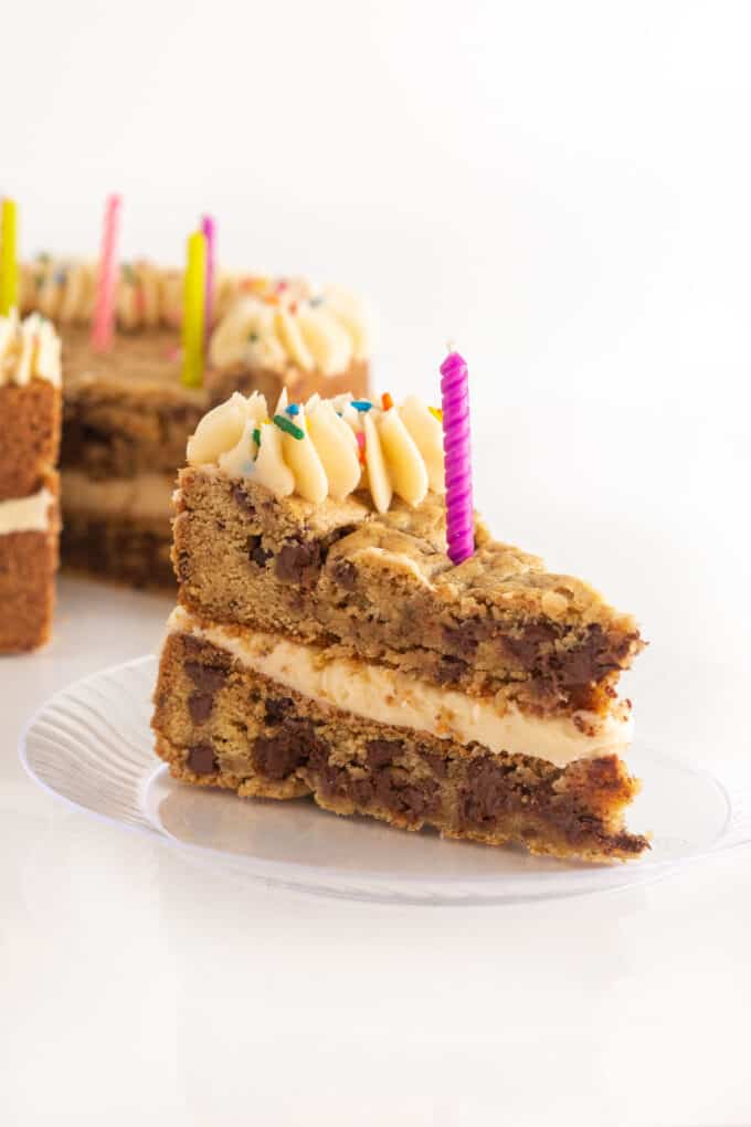 slice of chocolate chip double layer cookie cake with birthday candle