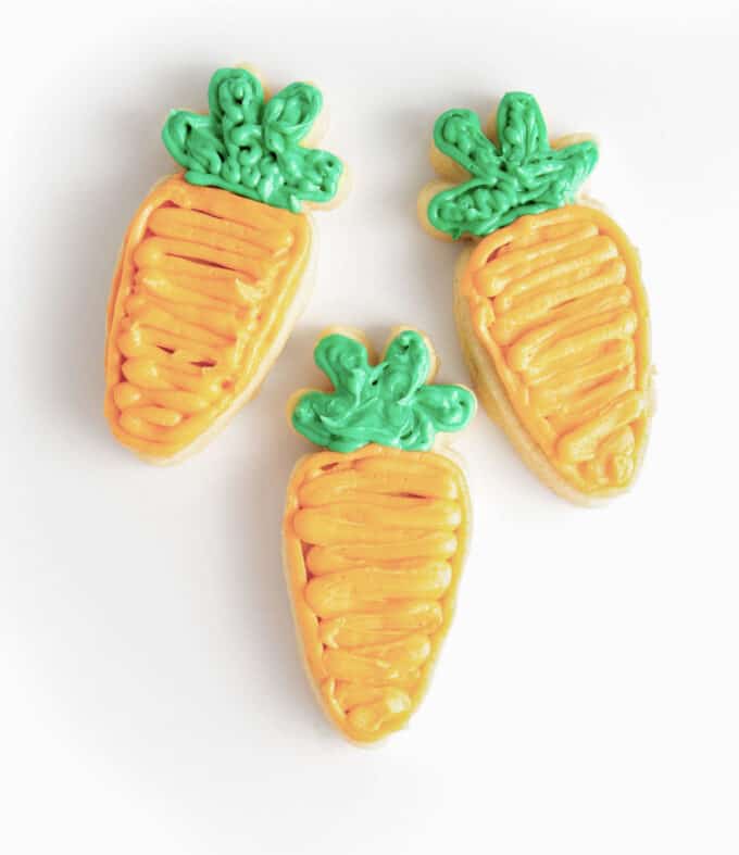 decorated carrot sugar cookie using orange and green frosting