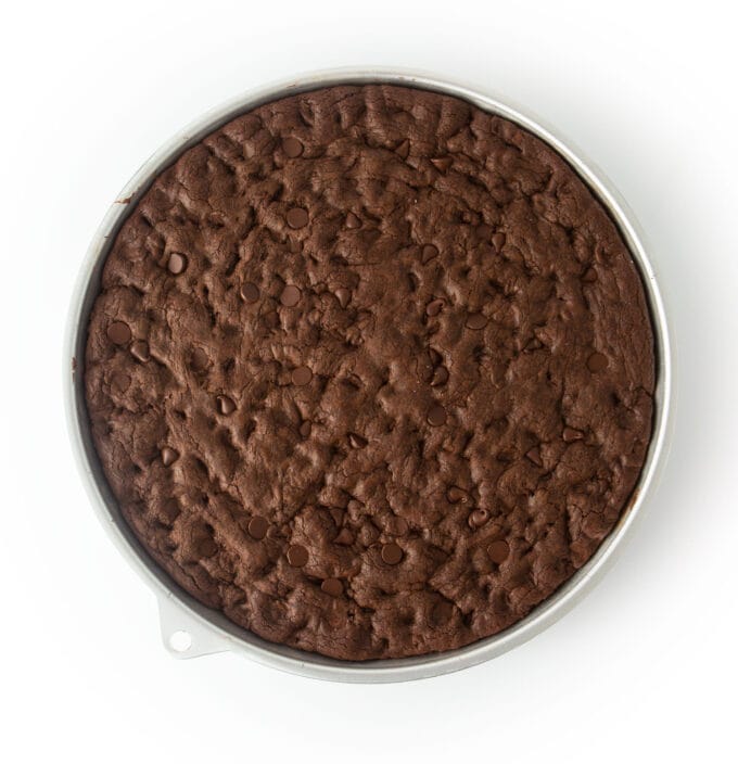 baked pan of triple chocolate cookie cake in round cookie cake pan