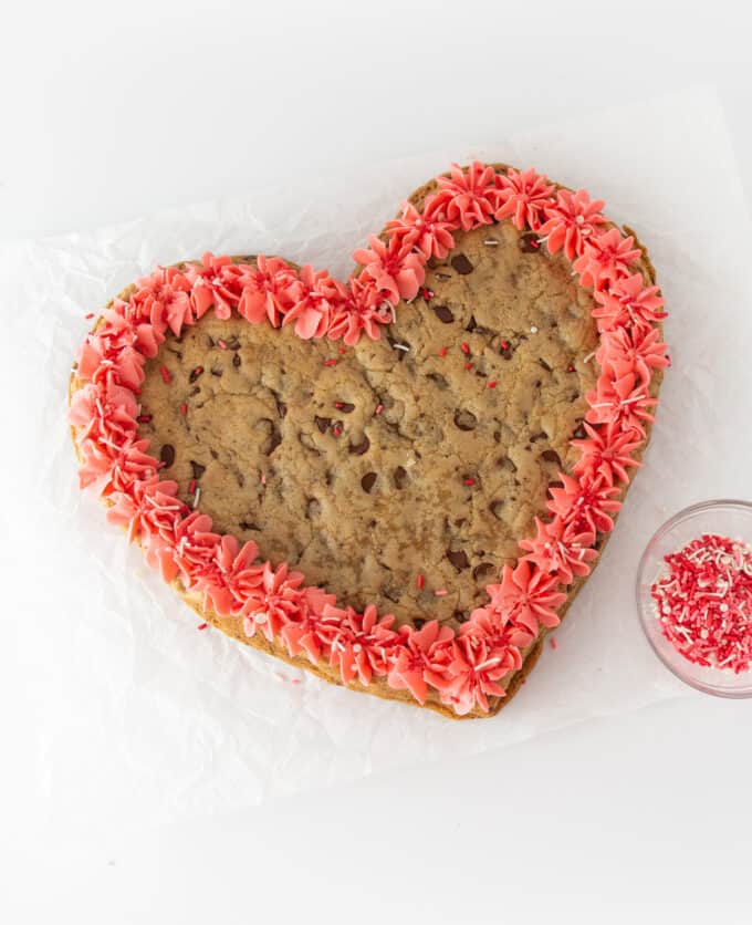 heart-shaped cookie cake for Valentines Day with pink frosting
