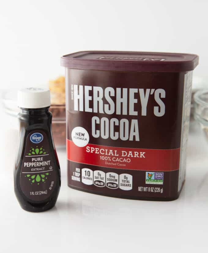 container of hershey's dark cocoa powder nad bottle of peppermint extract