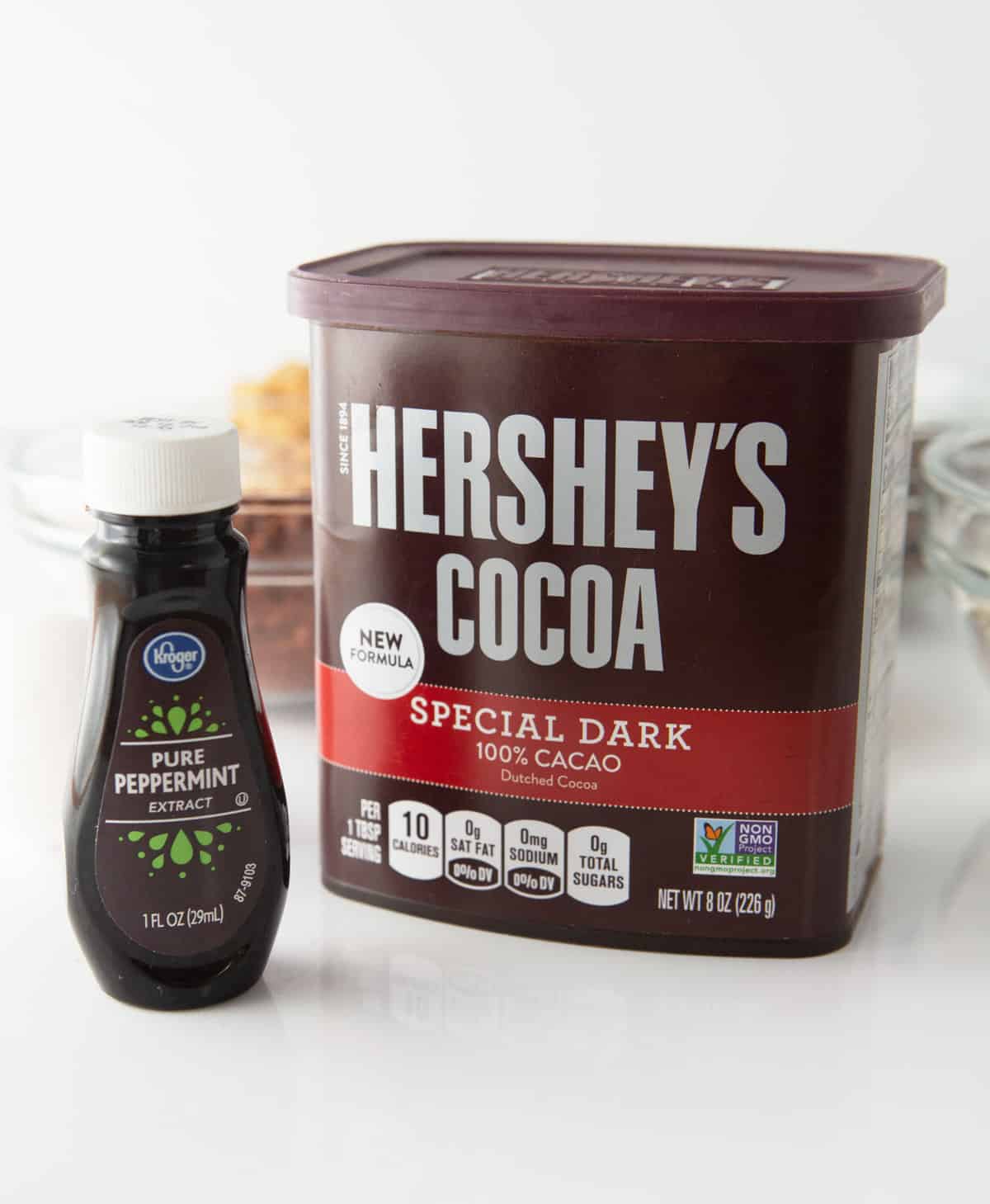 container of hershey's dark cocoa powder and bottle of peppermint extract
