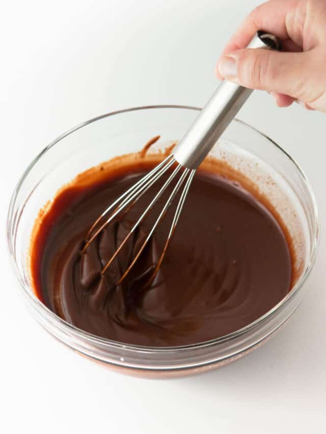 Whisking milk chocolate ganache in glass bowl