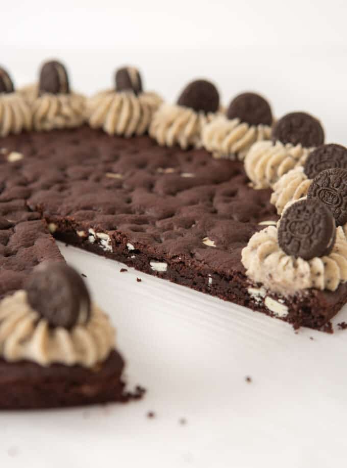 Oreo pizza cookie cake with one slice removed