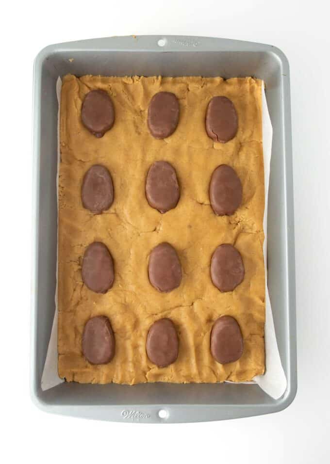 peanut butter cookie dough pressed into metal 9x13 pan and topped with Reese's eggs