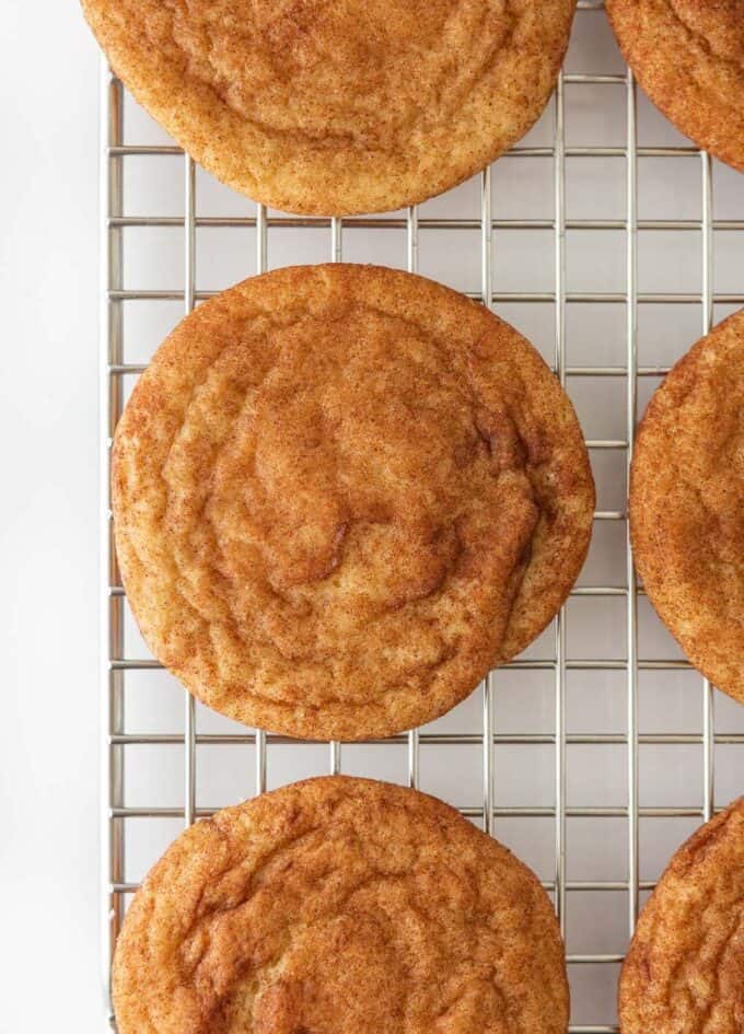 Cinnamon snickerdoodle cookies on metal cooling rack