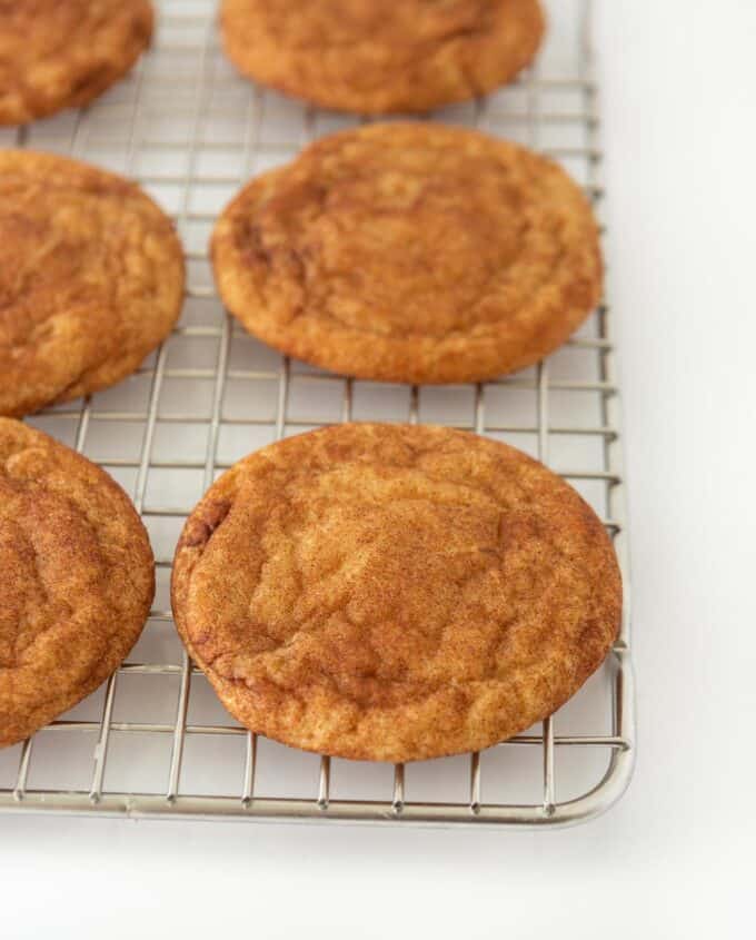 Cinnamon snickerdoodle cookies on metal cooling rack