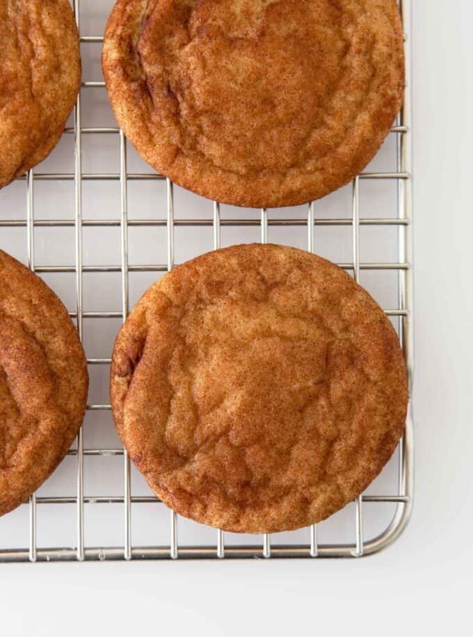 Cinnamon snickerdoodle cookies on metal cooling rack