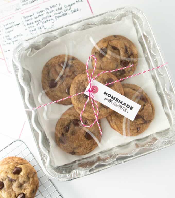 a foil square pan with baked chocolate chip cookies wrapped with string and "homemade with love" gift tag