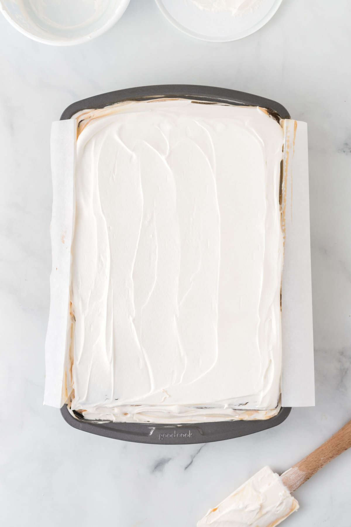 Overhead view of ice cream sandwich cake in pan after frosting