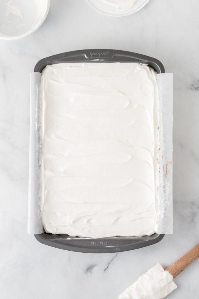 Overhead view of ice cream sandwich cake after adding whipped topping