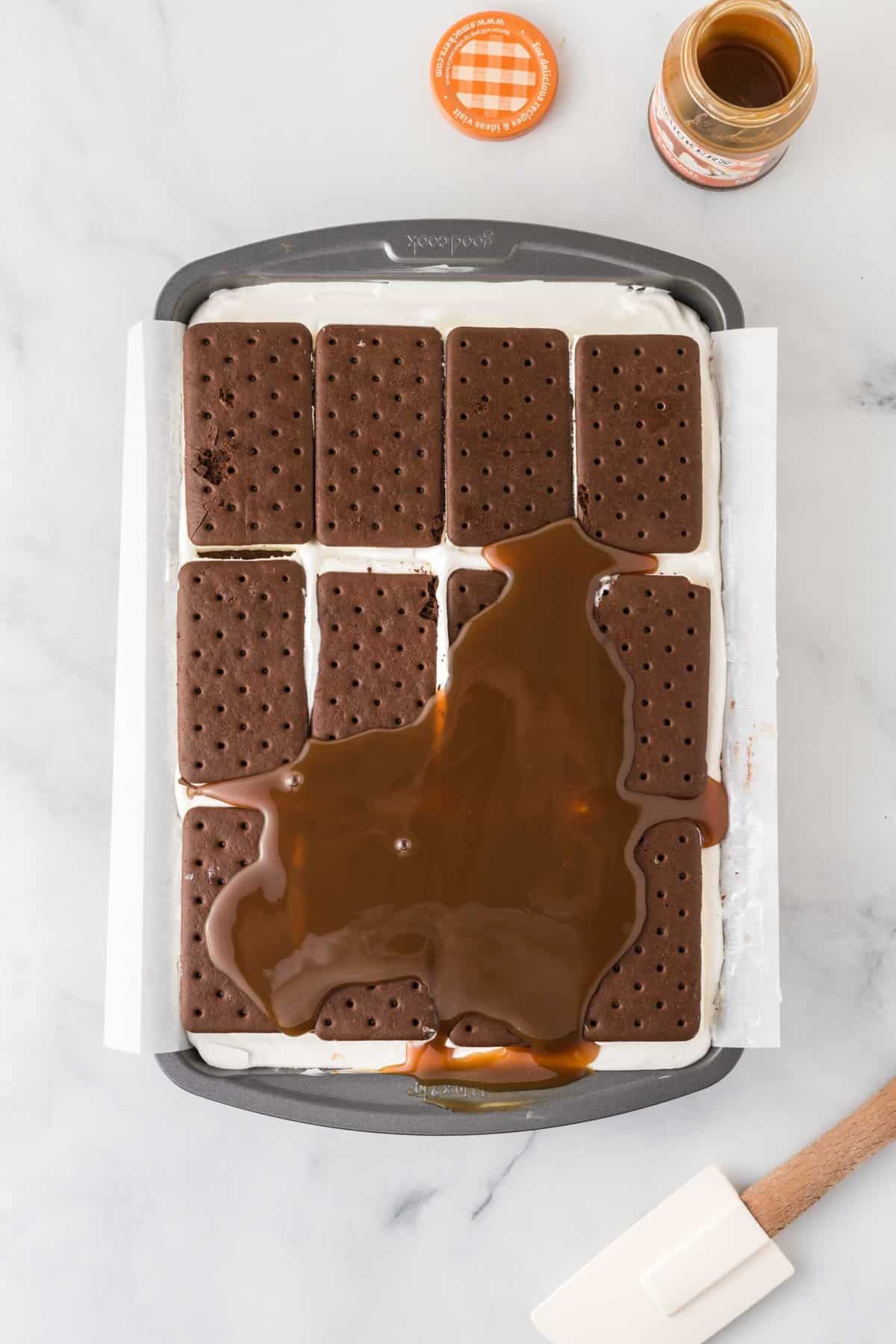 Caramel sauce poured onto ice cream sandwich cake