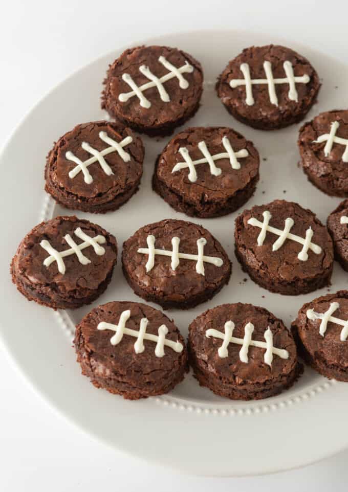 decorated football shaped brownies on white plate