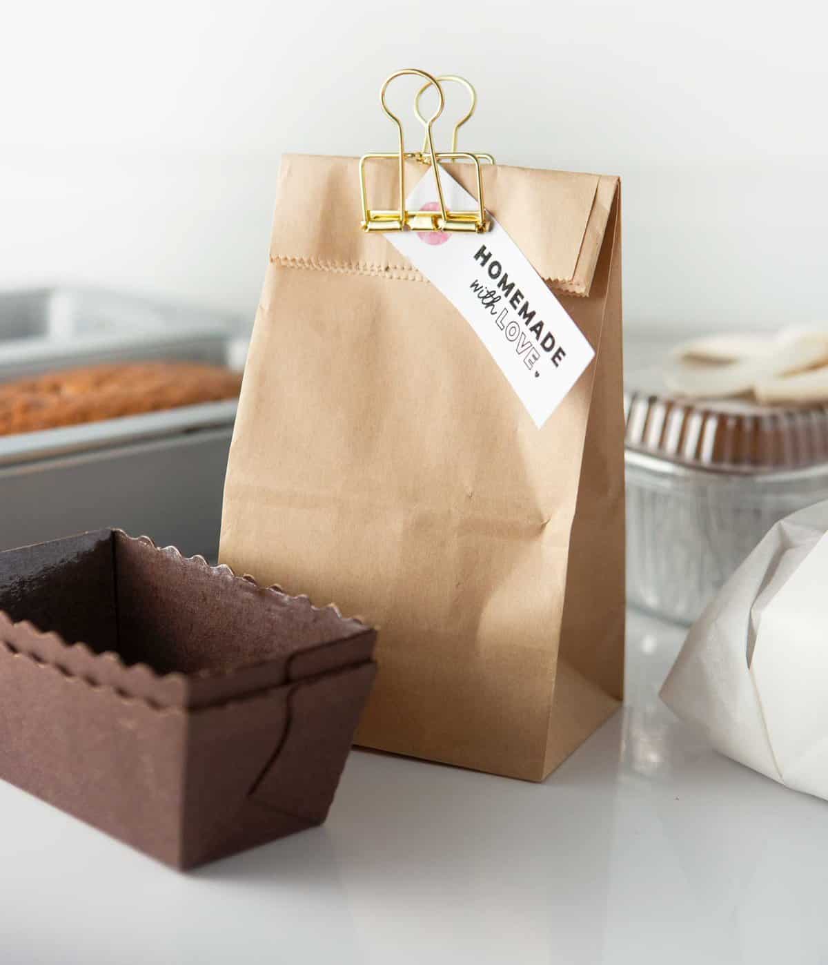 mini loaf of banana bread in brown paper bag