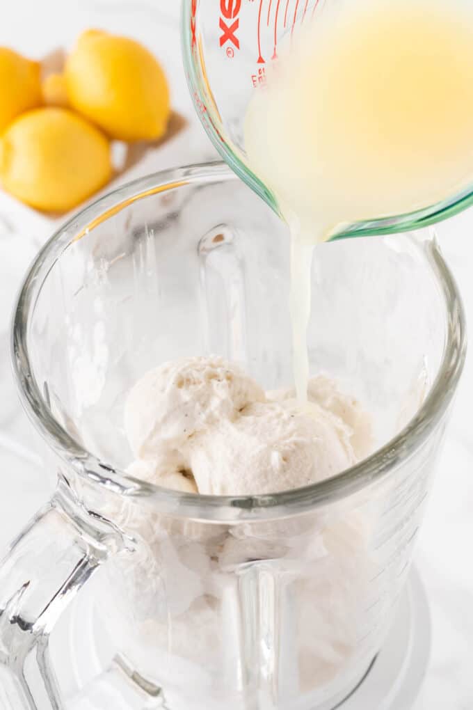 pouring lemon juice in a blender