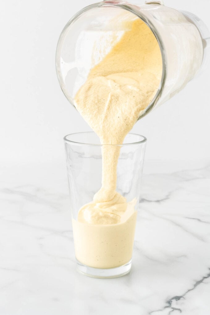 pouring frosted lemonade in glass cup