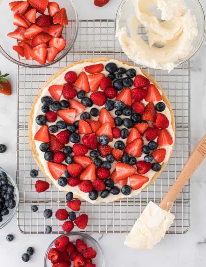 sugar cookie pizza topped with strawberries, blueberries, and raspberries