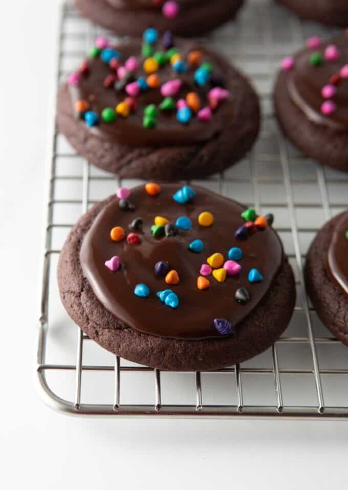 chocolate cosmic brownie cookies with rainbow sprinkles on metal cooling rack