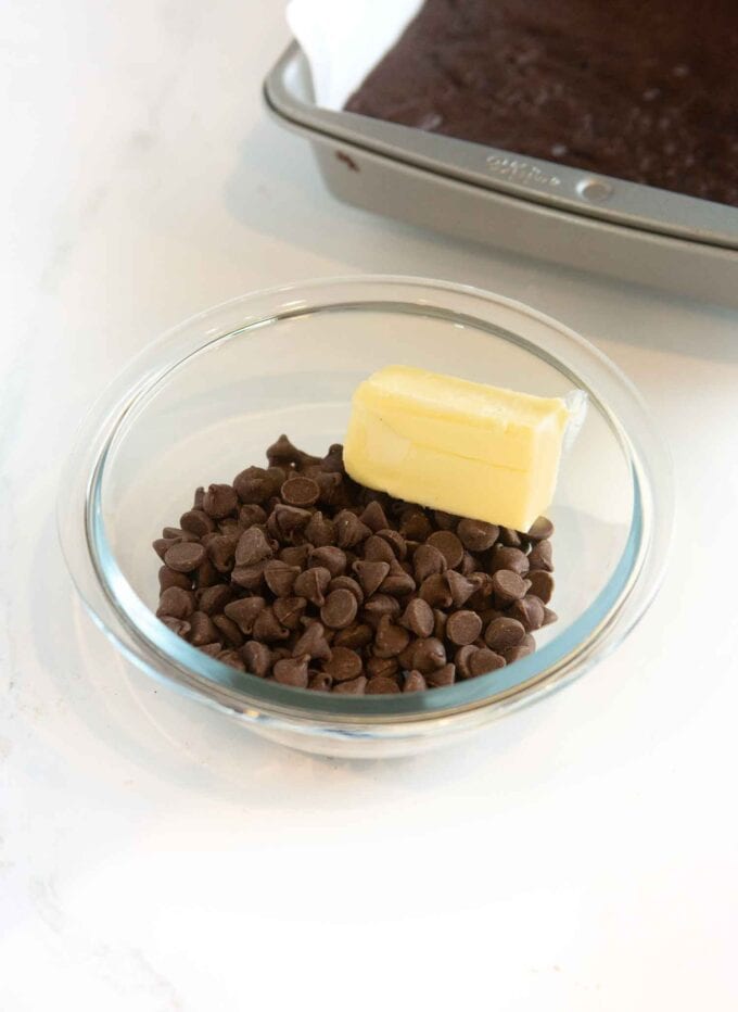 glass bowl with chocolate chips and half stick of butter