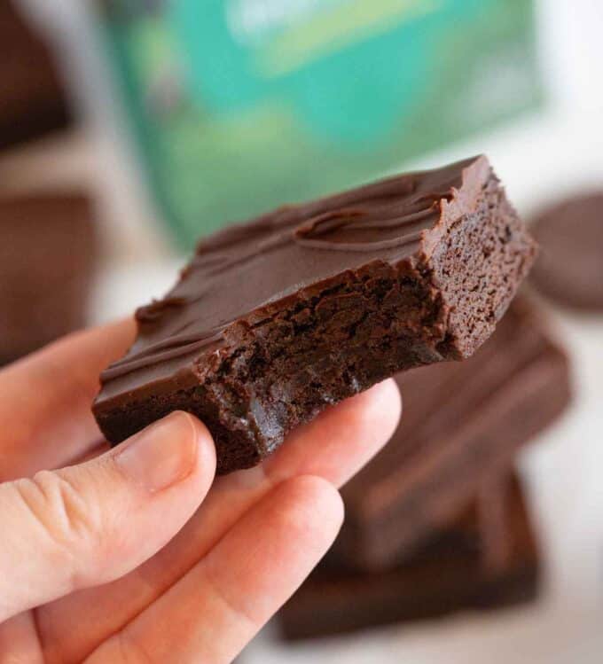 hand holding thin mint cookie bar square with bite
