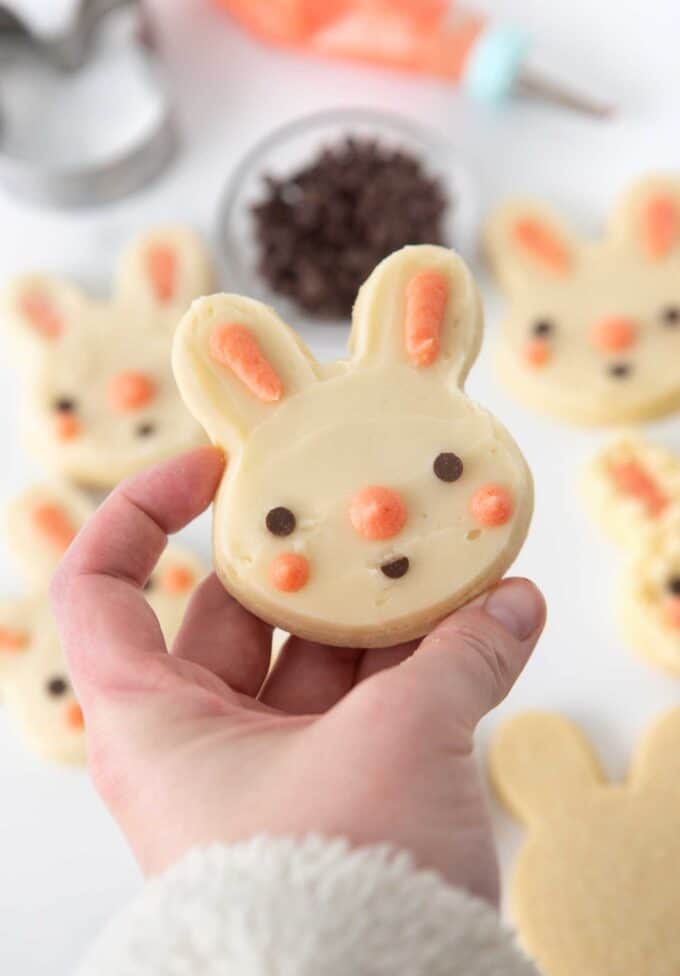 hand holding easter bunny face sugar cookie