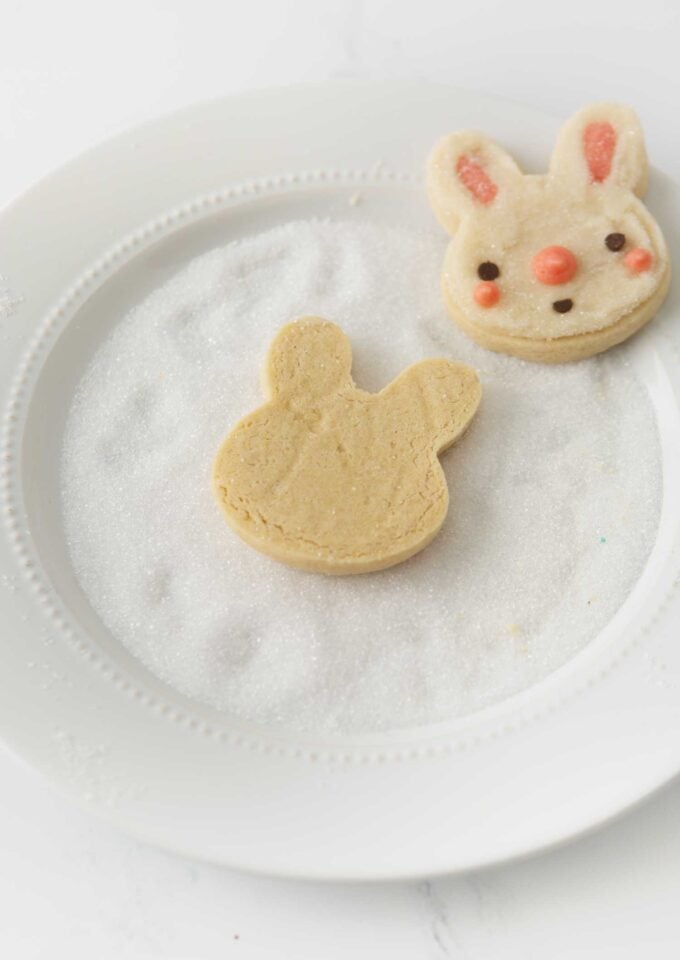 dipping bunny face sugar cookies in white sugar