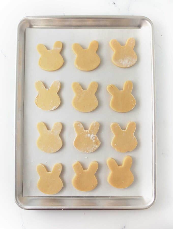 cookie sheet of unbaked bunny face cookies