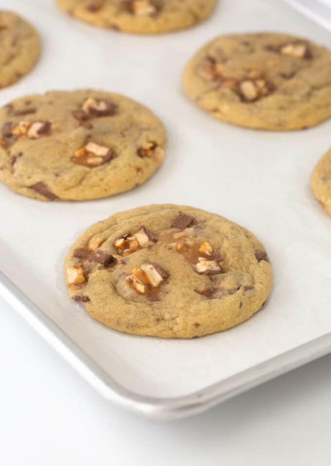 baked snickers cookie on cookie sheet