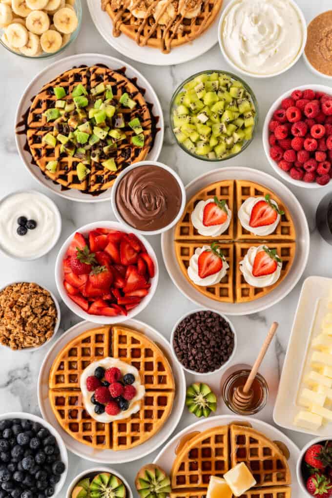 overhead of crispy waffles and waffle toppings for waffle bar