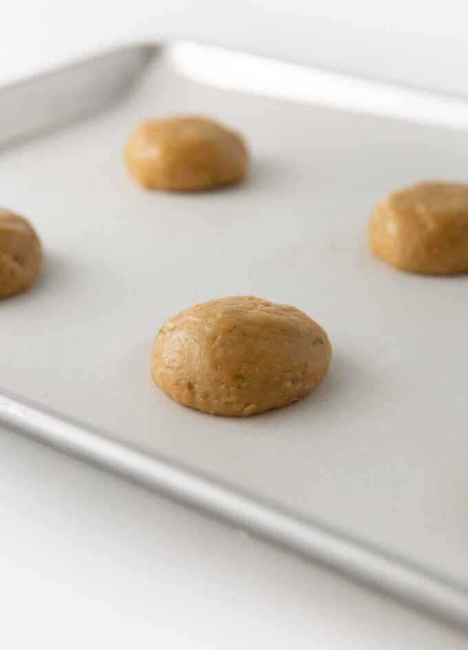 key lime cookie dough balls slightly flattened on baking tray
